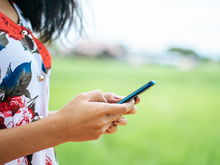 A young woman holding a cell phone