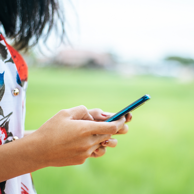 A young woman holding a cell phone